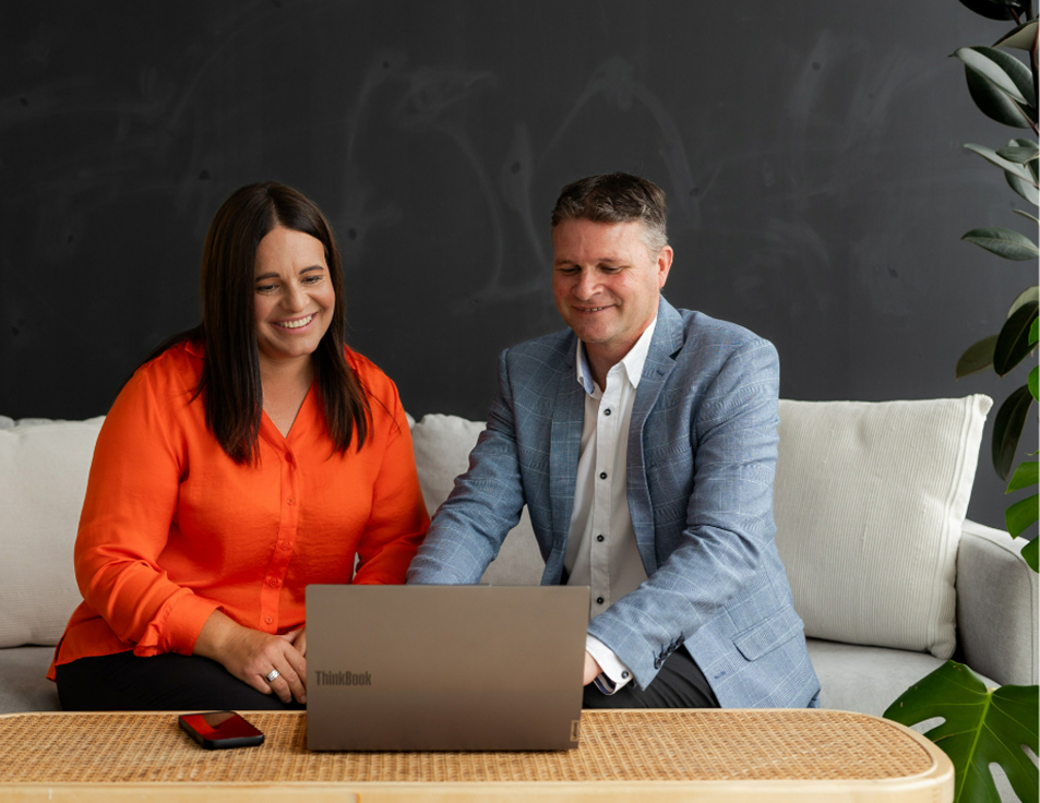 Toby and Kathryn Ferreira meeting working on a laptop